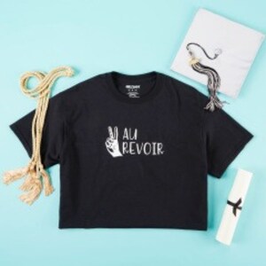 black t-shirt with white grad cap and ropes